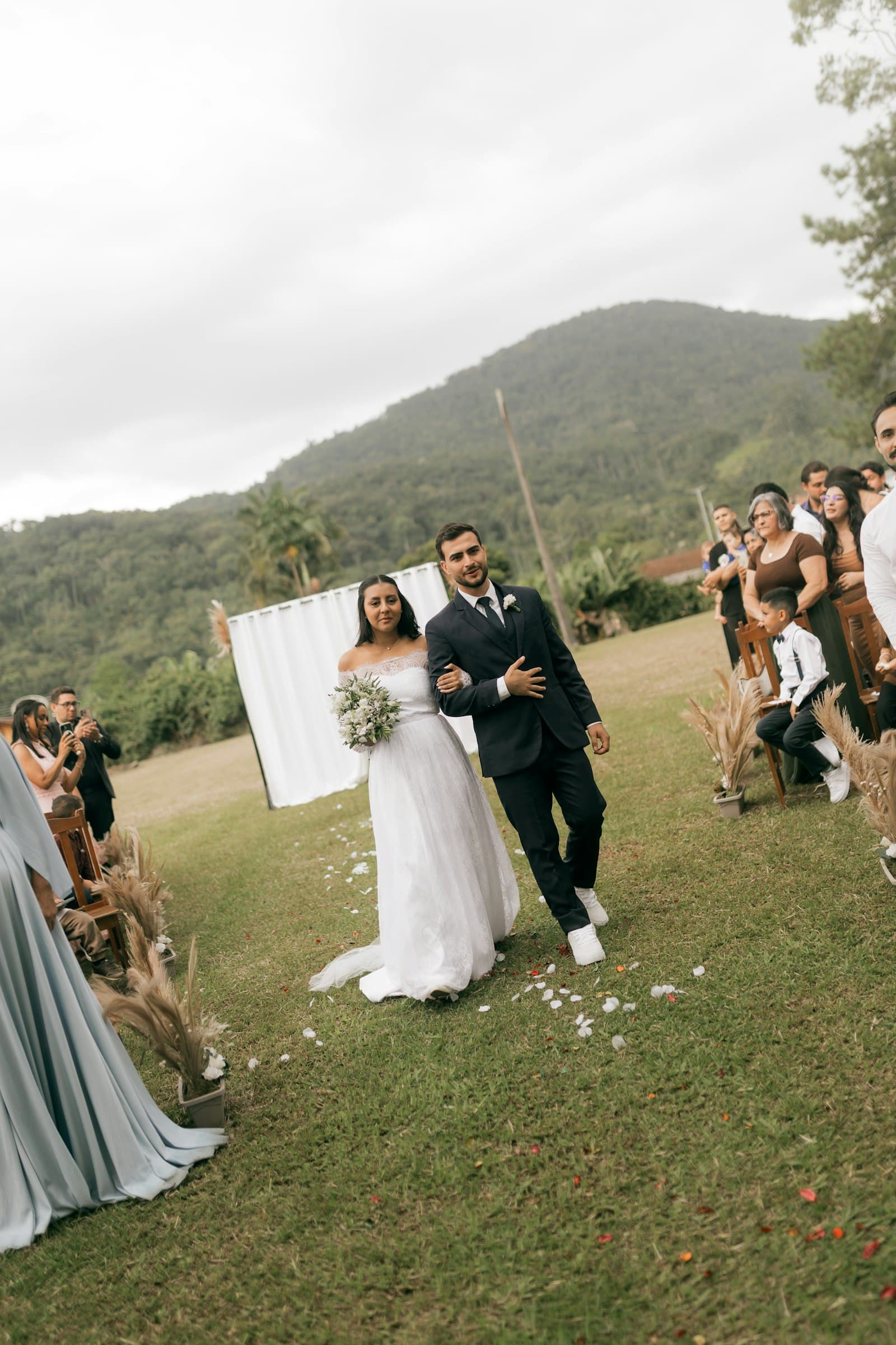 Bride and groom walking down the aisle at an outdoor wedding